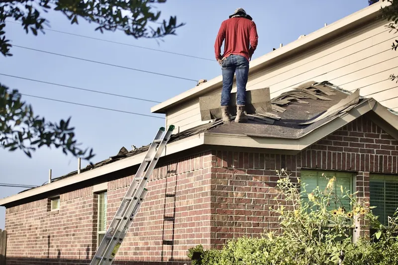 Professional roofer working on a residential roof in The Vineyard